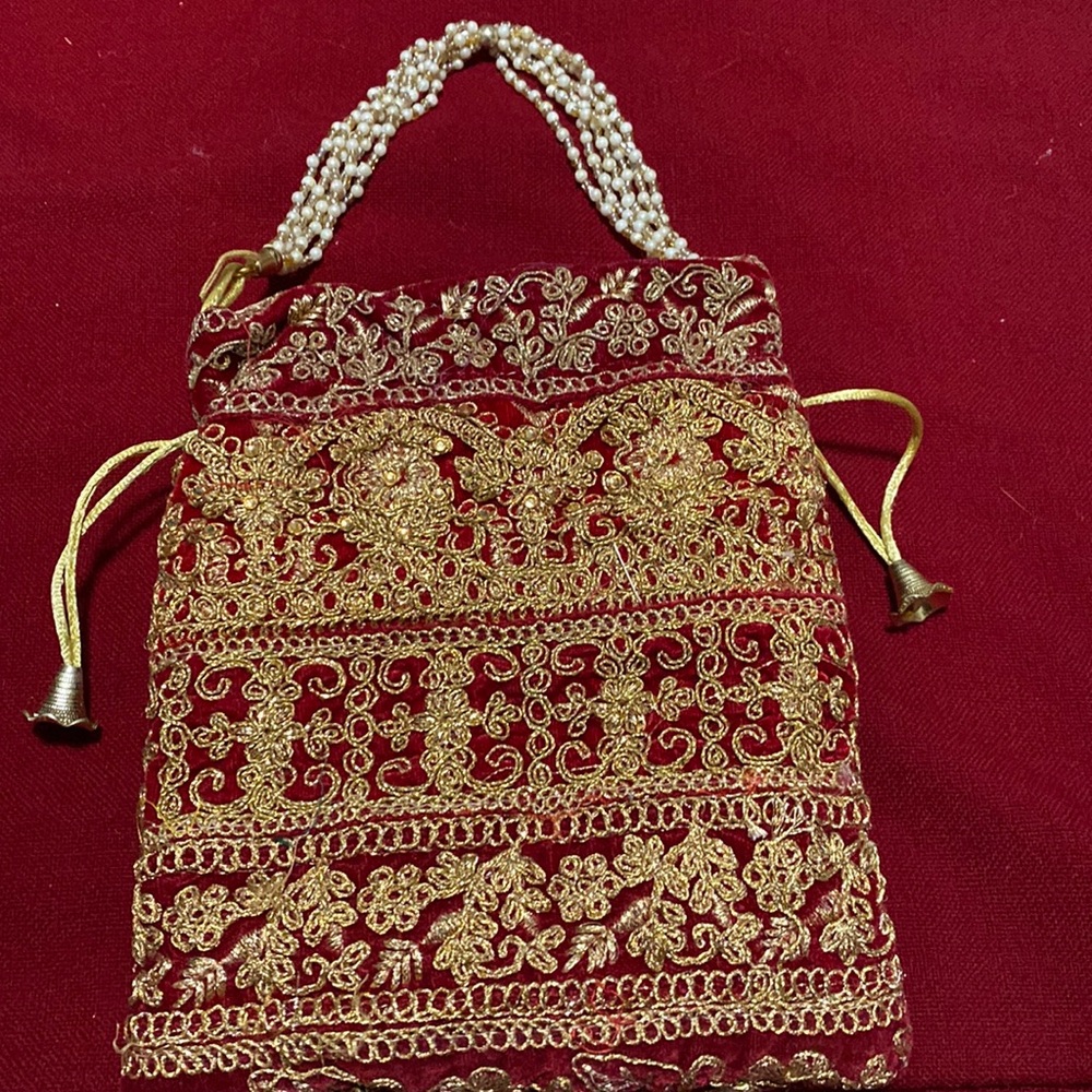 Brand new evening purse with gold embroidered work all around the purse